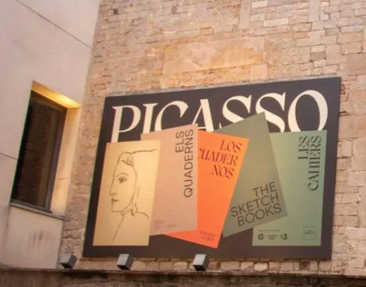 Signage for the Picasso Museum in Barcelona featuring an exhibition of his sketchbooks.